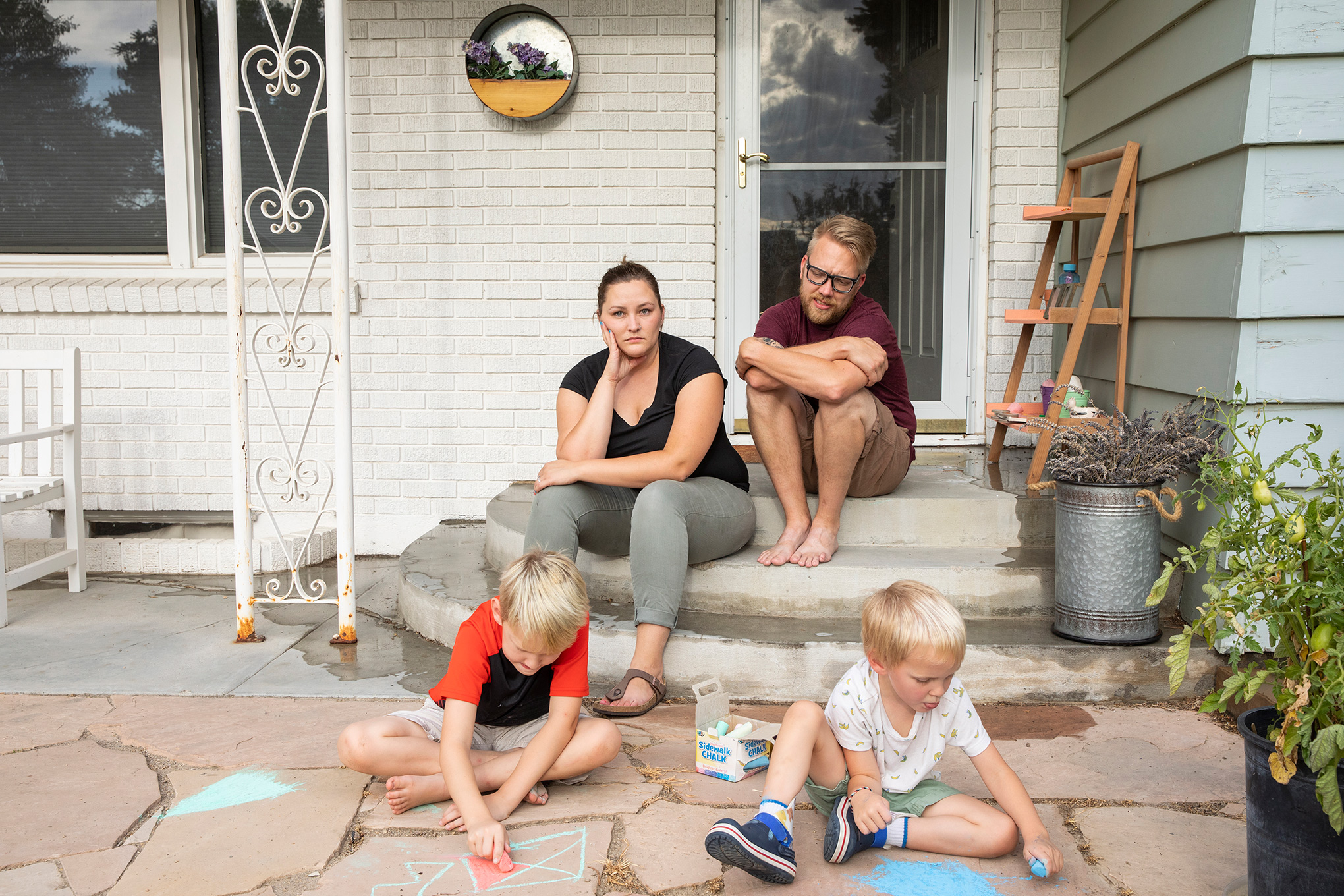 Kayla Brim with her family, outside their home in Caldwell, Idaho, on Aug. 11. Brim has been sick with COVID-19 since early July.